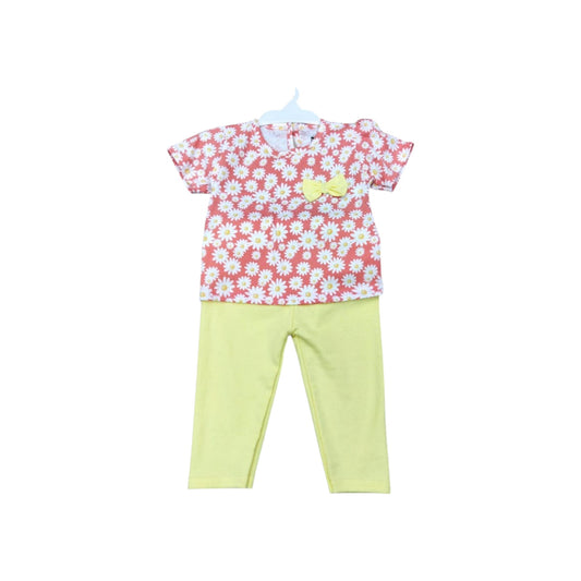 Children's outfit with floral top and yellow pants on a white background