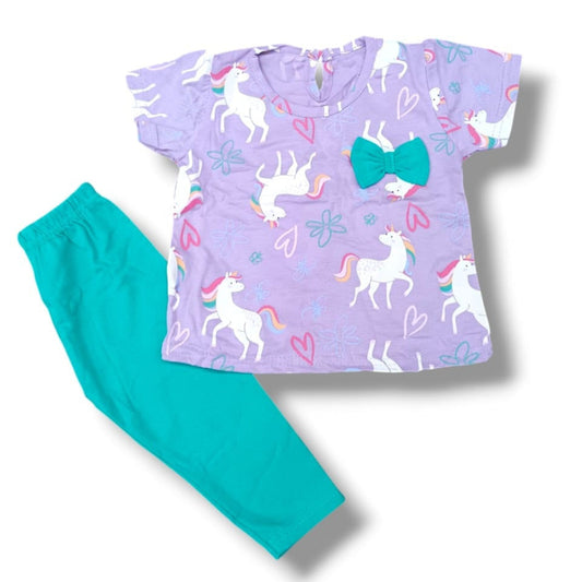 Children's pajama set with purple top and teal pants featuring unicorn and bow designs on a white background.