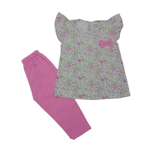 Floral top with a bow and pink pants on a white background