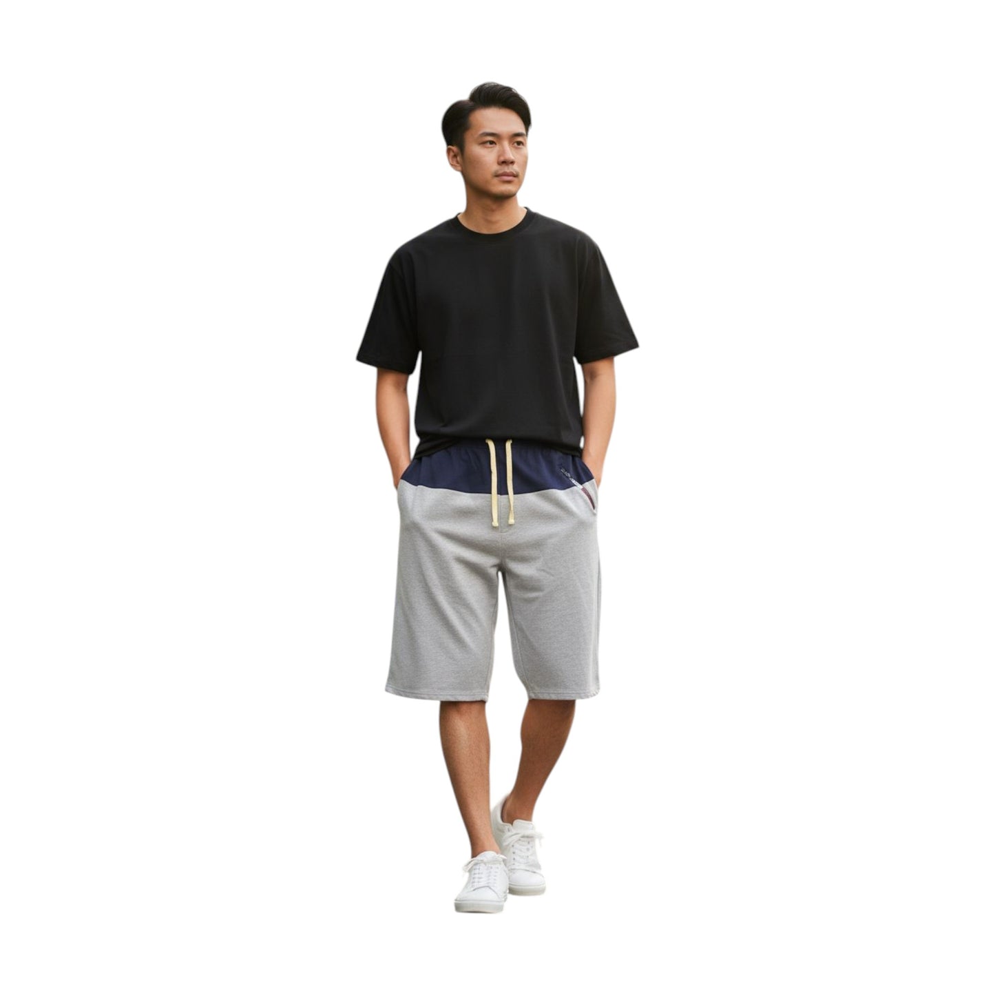 Man wearing a black t-shirt and gray shorts on a white background