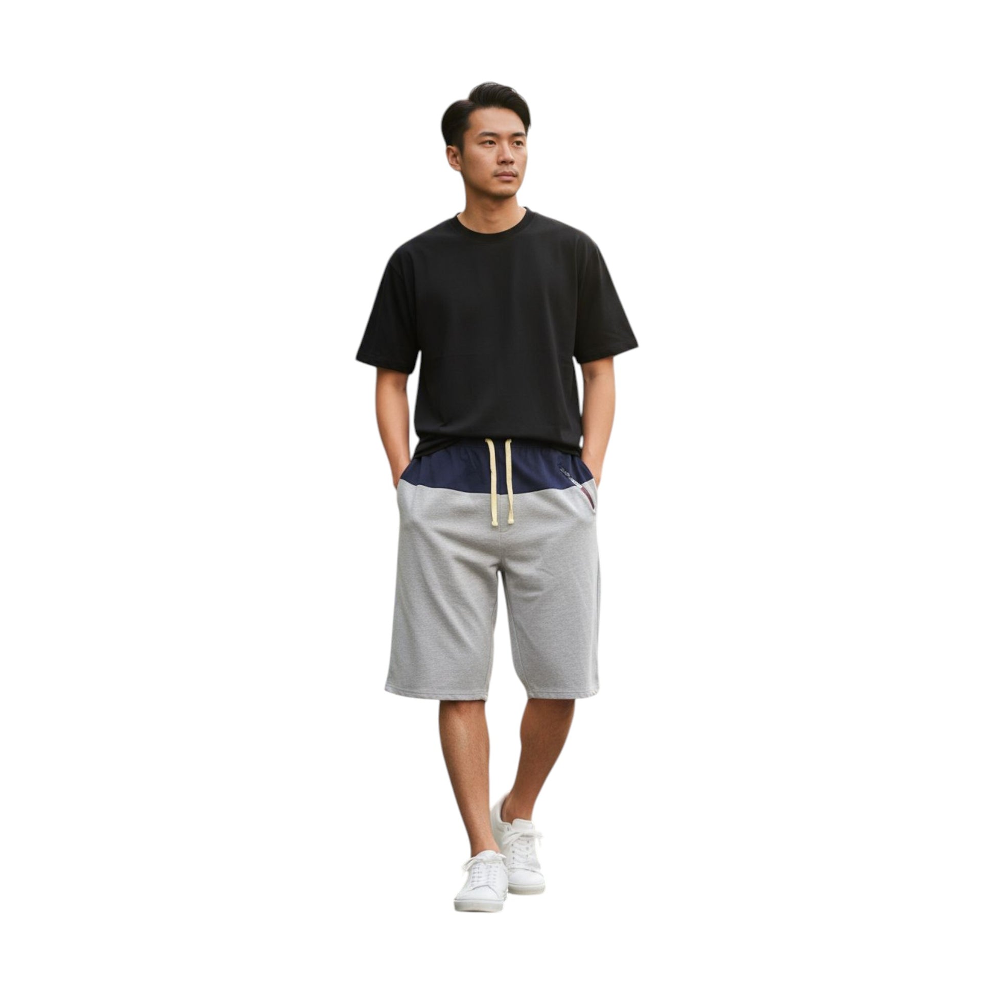 Man wearing a black t-shirt and gray shorts on a white background