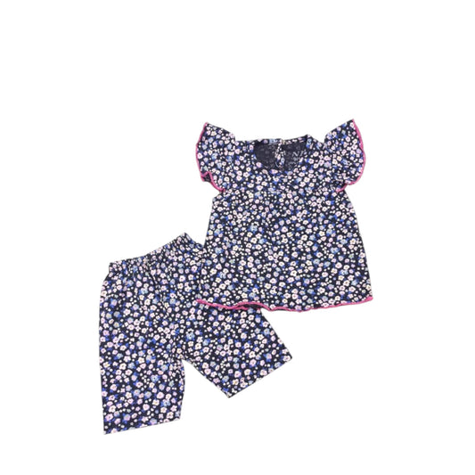 Navy floral top and shorts set on a white background
