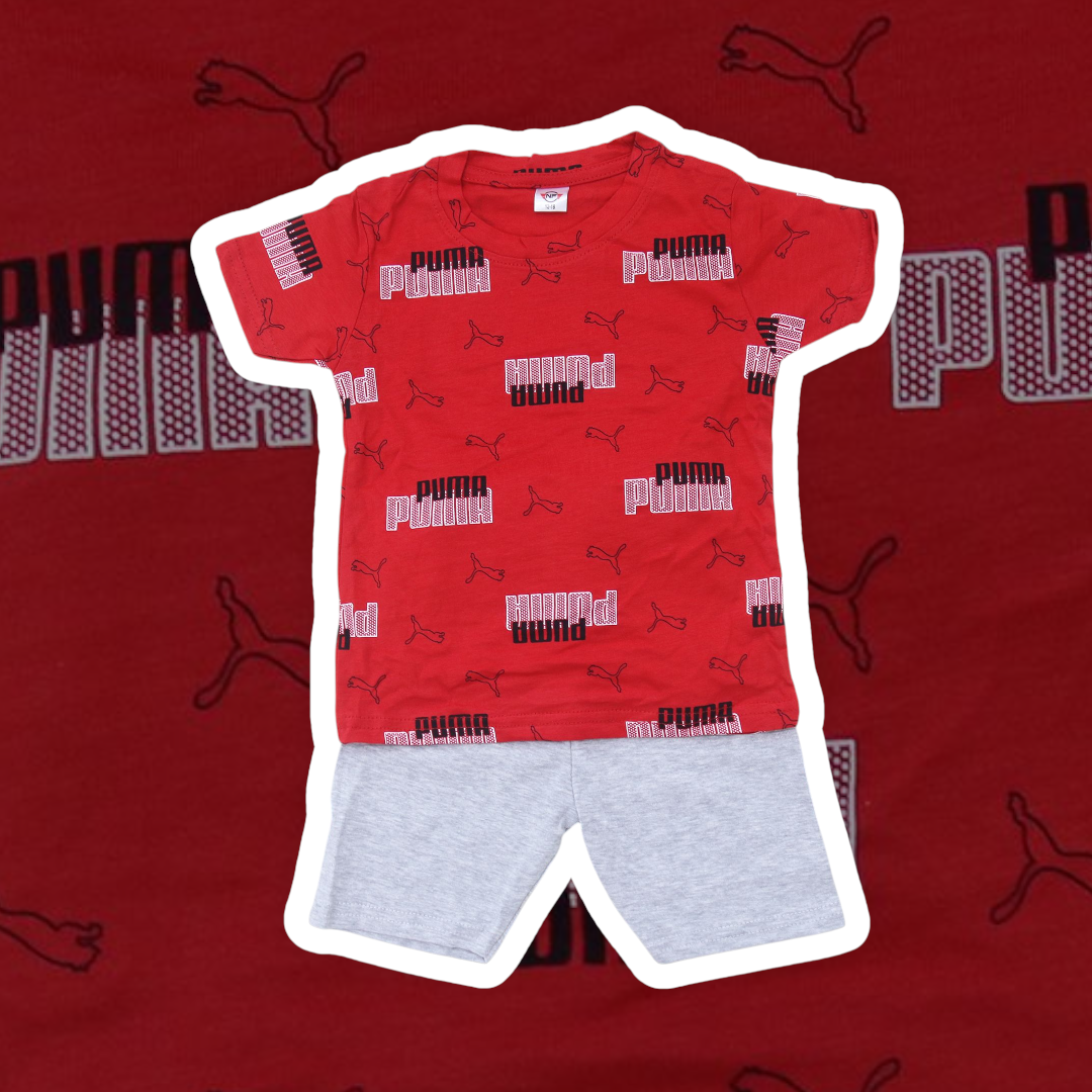 Red Puma t-shirt with logo pattern and gray shorts on a red background